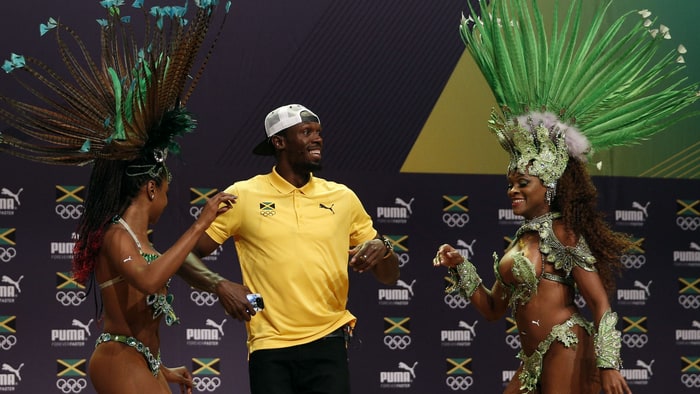 Usain Bolt with samba dancers at Olympic press confrence in Rio de Janeiro        
      Credit Adrian Dennis  Getty