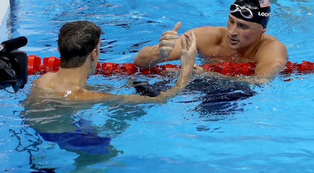 RIO DE JANEIRO BRAZIL- AUGUST 11 Michael Phelps of the United States shakes hands with Ryan Lochte of the United States after winning the Men's 200m Individual Medley Final on Day 6 of the Rio 2016 Olympic Games at the Olympic Aquatics Stadium