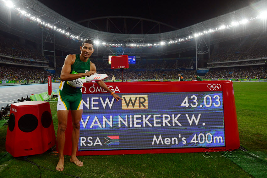 Gold medallist South Africa's Wayde van Niekerk points to his new world record displayed