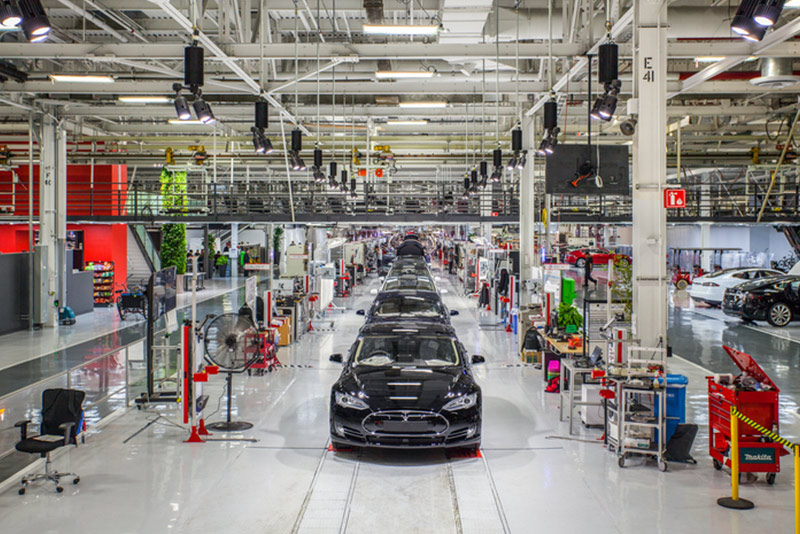 Vehicles move down the assembly line at Tesla's Fremont Calif. factory