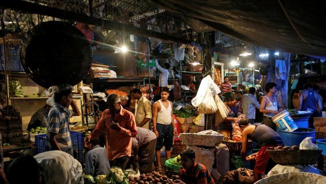 Vendors work at a wholesale vegetable market in Mumbai on Tuesday