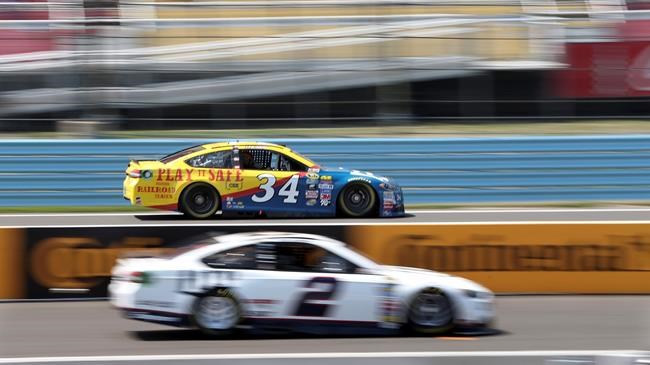 Chris Buescher drives past the pits and Brad Keselowski during practice at Watkins Glen International race track for Sunday's NASCAR Sprint Cup Series Cheez It 355 auto race Friday Aug. 5 2016 in Watkins Glen N.Y