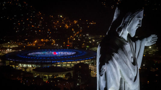 Christ the Redeemer statue seen at sunset in front of the Maracana Stadium ahead of the 2016 Summer Olympic Games in Rio de Janeiro