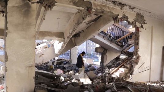 Yemen- Sadiq Rubeid inspects the ruins of his family's home