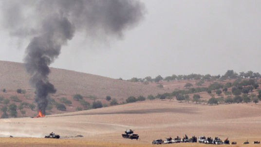 Turkish army tanks and Turkish-backed Syrian fighters make their way to Jarablus