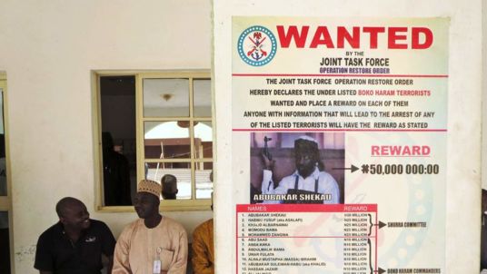 A poster advertising for the search of Boko Haram leader Abubakar Shekau is pasted on a wall in Baga