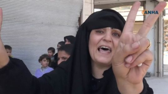 A resident celebrates the liberation of Syria's Manbij from Islamic State