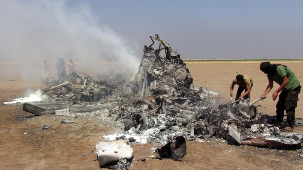 1 2016 reportedly shows Syrian rebels inspecting the wreckage of a Russian Mi-8 military transport helicopter after it was shot down along the administrative border between Idlib province northwestern Syria and neighbouring Ale