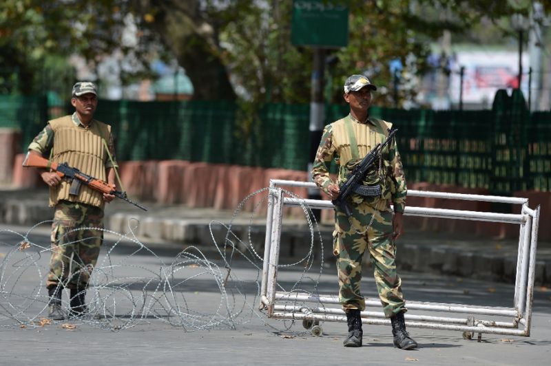 Indian paramilitary troopers stand guard during a curfew in Srinagar