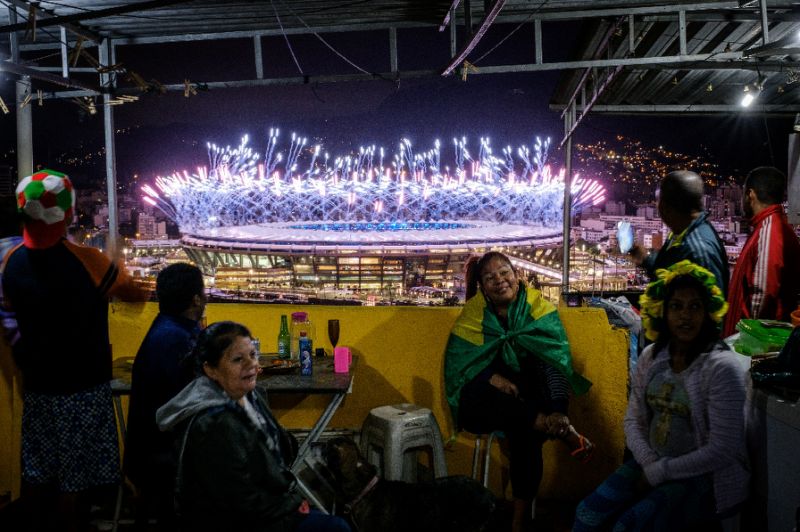 Residents watch the Rio Olympics closing ceremony from the Manugeira favela in Rio de Janeiro