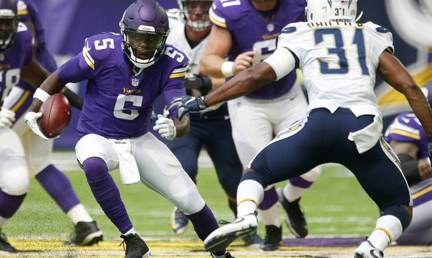 Minnesota Vikings quarterback Teddy Bridgewater scrambles upfield ahead of San Diego Chargers cornerback Adrian Phillips during the first half of an NFL preseason football game Sunday Aug. 28 2016 in Minneapolis