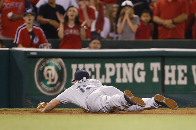 Seattle Mariners third baseman Kyle Seager stops a ball hit by Los Angeles Angels Andrelton Simmons before throwing him out at first base to end the game