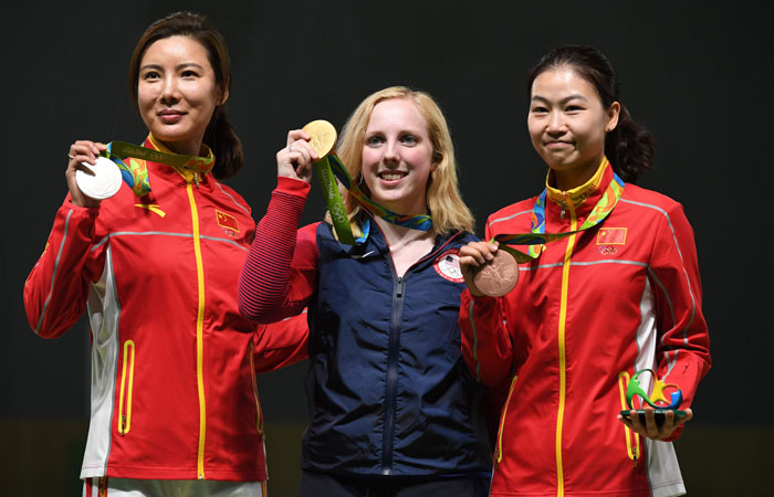 American gold medalist Virginia Thrasher poses on the podium with China's silver medal winner Du Li and China's bronze medalist Yi Siling during the medal ceremony for the women's 10m air rifle shooting event at the Rio 2016 Olympic