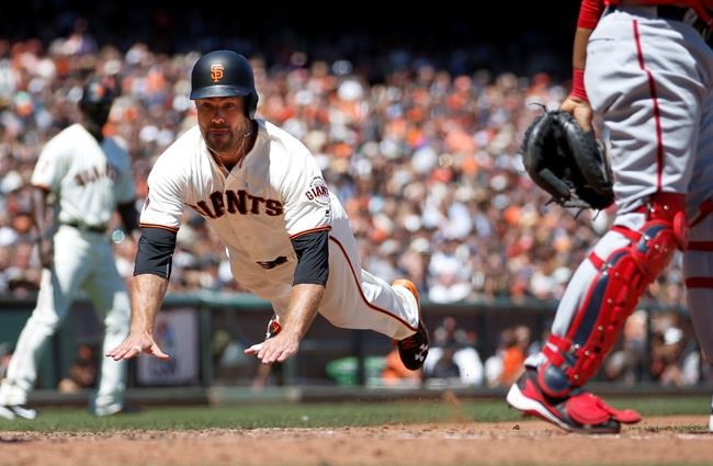 San Francisco Giants&#39 Mac Williamson left slides into home plate past Washington Nationals catcher Pedro Severino right on a ground ball by Angel Pagan during the fourth inning of a baseball game in San Francisco Saturday