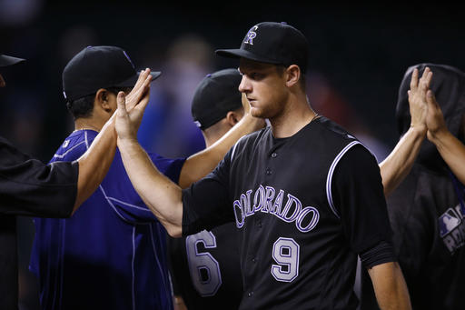 Colorado Rockies DJ Le Mahieu is congratulated by teammates after helping to retire the Washington Nationals in the ninth inning of a baseball game Tuesday Aug. 16 2016 in Denver. Colorado won 6-2