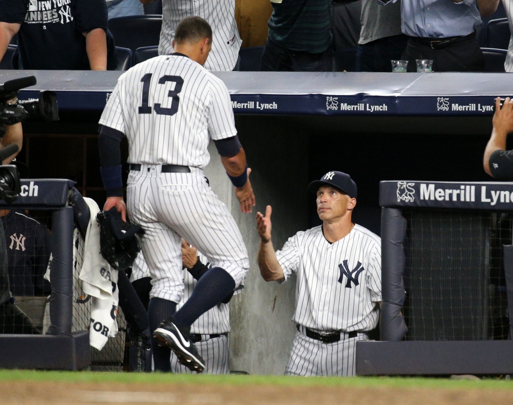 NEW YORK NY- AUGUST 12 Alex Rodriguez #13 of the New York Yankees is greeted by manager Joe Girardi #28 after being taken out of the game in the top of the ninth inning against the Tampa Bay Rays