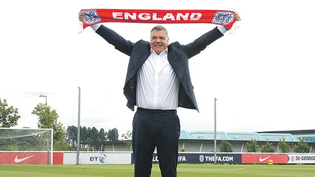 Proud man... Sam Allardyce poses with an England scarf yesterday