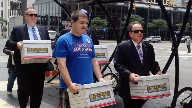 Libertarian Party activists in Ohio carry boxes of signature petitions to the Secretary of State's Office Tuesday Aug. 9 2016 in Columbus Ohio in hopes of placing presidential candidate Gary Johnson on the November ballot. The party surprised