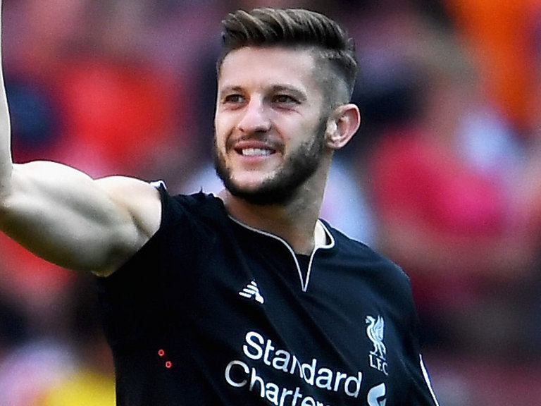 Adam Lallana celebrates Liverpool's victory at Arsenal