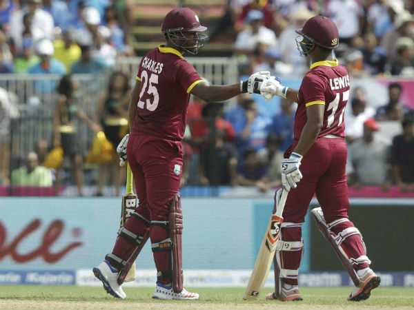 West Indies openers Johnson Charles and Evin Lewis celebrate during their partnership against India in 1st T20I