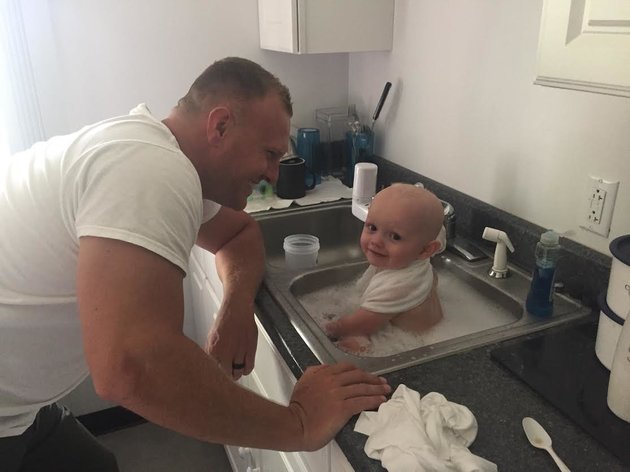 West Virginia State Police
A West Virginia State trooper is seen bathing a baby who was found in an alleged DUI driver's vehicle on Tuesday