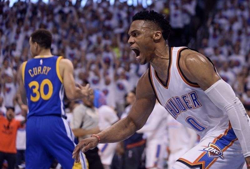 Oklahoma City Thunder guard Russell Westbrook reacts in front of Golden State Warriors guard Stephen Curry during the first quarter in game four of the Western conference finals of the NBA Playoffs at Chesapeake Energy Arena. Mandatory Credit Ma