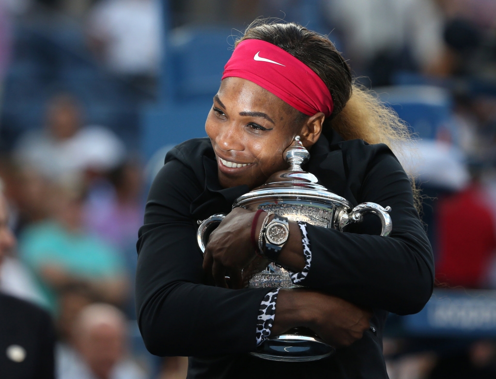 Serena Williams of the United States hugs the championship trophy after defeating Caroline Wozniacki of Denmark during the championship match of the 2014 U.S. Open tennis tournament in New York. She is at the