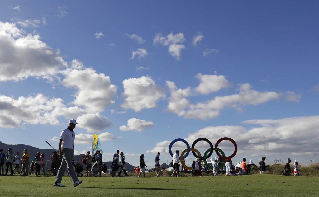 Rickie Fowler of the United States left walks off the tee on the 17th hole during the first round of the men's golf event at the 2016 Summer Olympics in Rio de Janeiro Brazil Thursday Aug. 11 2016