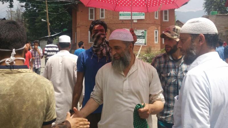 Slain militant commander Burhan's father Muzaffar Ahmed Wani receiving people at a memorial rally held on the Rasm-e-Qul the 4th day after his death