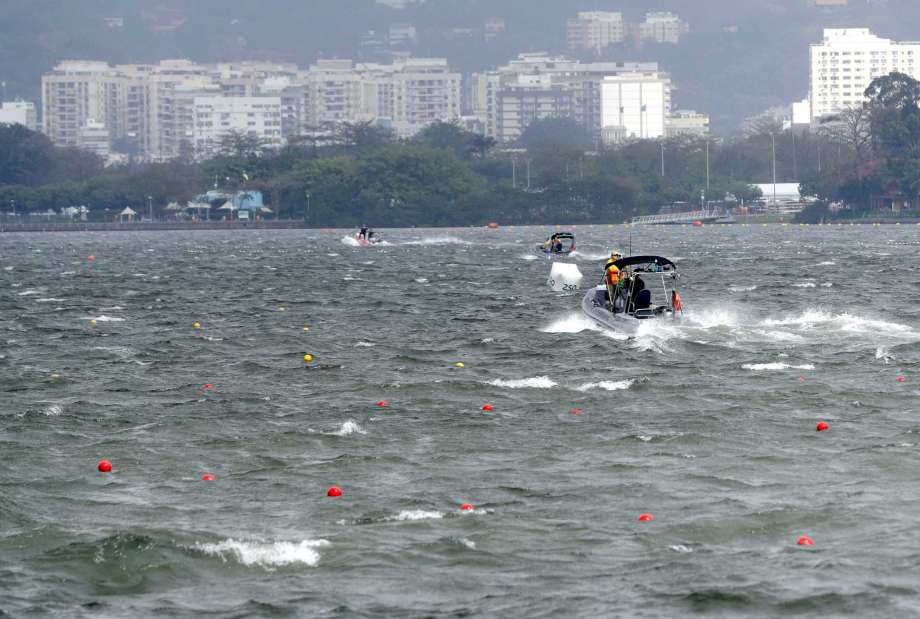 Boats return to dock after removing rowers who were training to shore after high winds postponed their competition for the day at the 2016 Summer Olympics in Rio de Janeiro Brazil Sunday Aug. 7 2016