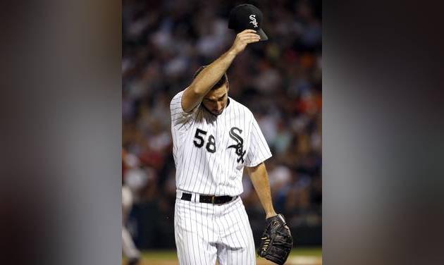 Chicago White Sox starter Miguel Gonzalez wipes his face as he walks back to the dugout during the sixth inning of a baseball game against the Baltimore Orioles Friday Aug. 5 2016 in Chicago