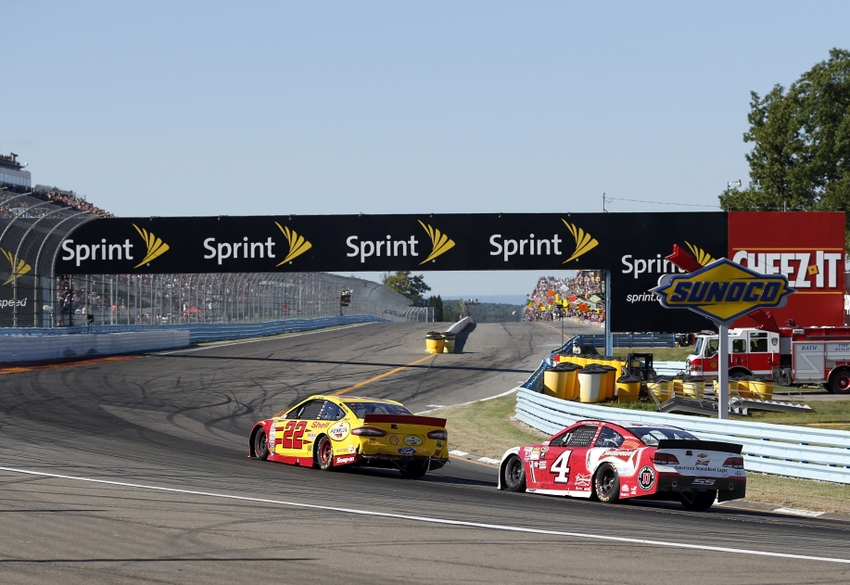 Aug 9 2015 Watkins Glen NY USA Sprint Cup Series driver Joey Logano passes driver Kevin Harvick on the final turn of the final lap to win the the Cheez It 355 at Watkins Glen International. Mandatory Credit Kevin Hoffman-USA TODAY Sports