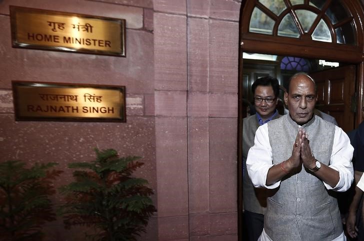 India's Home Minister Rajnath Singh greets the media as he leaves his office after taking charge inside the home ministry in New Delhi