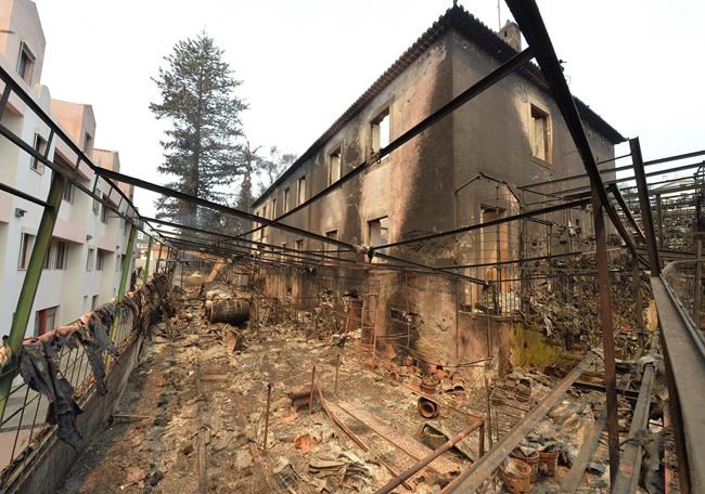 Debris litters the remains of a burnt building in Funchal the capital of Portugal's Madeira island Wednesday Aug. 10 2016. The building belonging to a flower-producing company was caught in the forest fires that are raging in Madeira and have forced