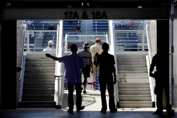 Tennis fans walk into the seating area