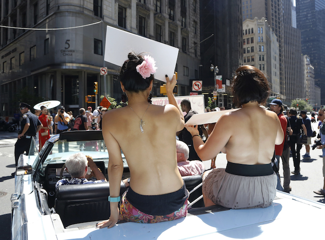 EDS NOTE NUDITY Participants ride in a convertible through midtown Manhattan in the Go Topless Pride Parade Sunday Aug. 28 2016 in New York. Go Topless Day is celebrated annually on the Sunday closest to Women's Equality Day marking the day American