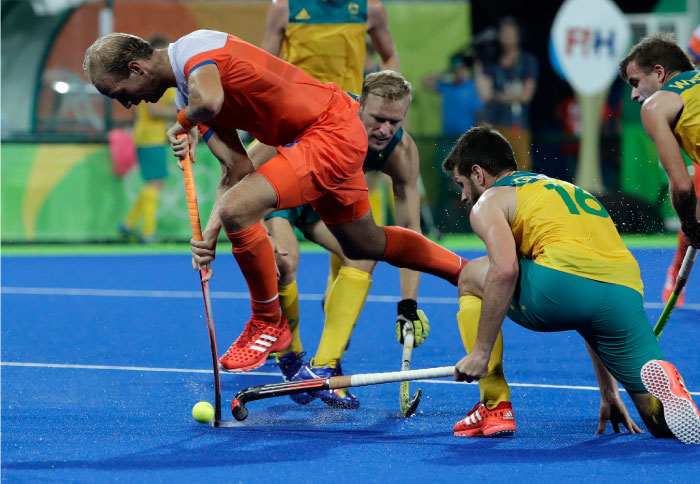 Netherlands Billy Bakker fight for the ball with Australia's Matt Ghodes during their field hockey quarterfinal match at the 2016 Summer Olympics in Rio Sunday. — AP