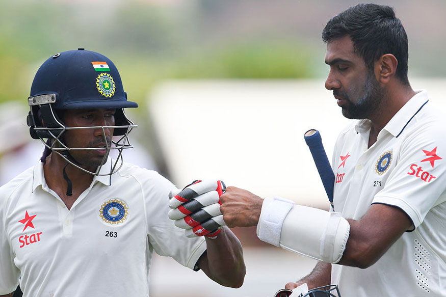 Wriddhiman Saha and Ravichandran Ashwin of India leave the field at lunch during day 2 of the 3rd Test between West Indies and India