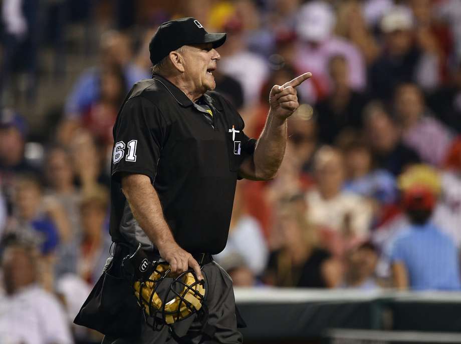 Home-plate umpire Bob Davidson points toward an unruly fan who was ejected from Citizens Bank Park