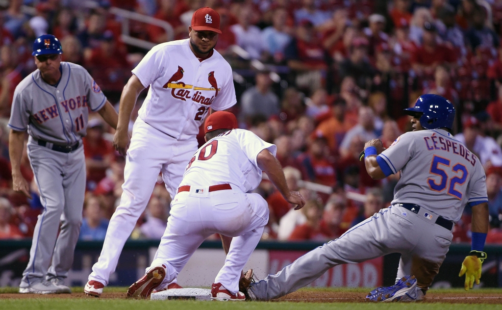 Aug 25 2016 St. Louis MO USA New York Mets left fielder Yoenis Cespedes slides safely as St. Louis Cardinals starting pitcher Adam Wainwright tries to apply the tag during the fifth inning at Busch Stadium. Mandatory Credit Jeff Curry-USA