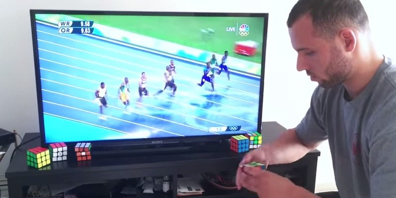 Anthony Brooks attempting to solve a Rubik's Cube before Jamaican sprinter Usain Bolt wins gold in the men's 100-meter race at the 2016 Summer Olympics in Rio