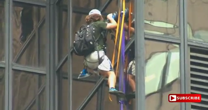 Guy climbing Trump Tower with suction cups