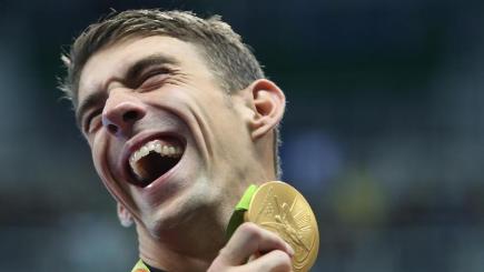 Michael Phelps celebrates after his team wins gold in the Men's 4 x 100m medley relay final