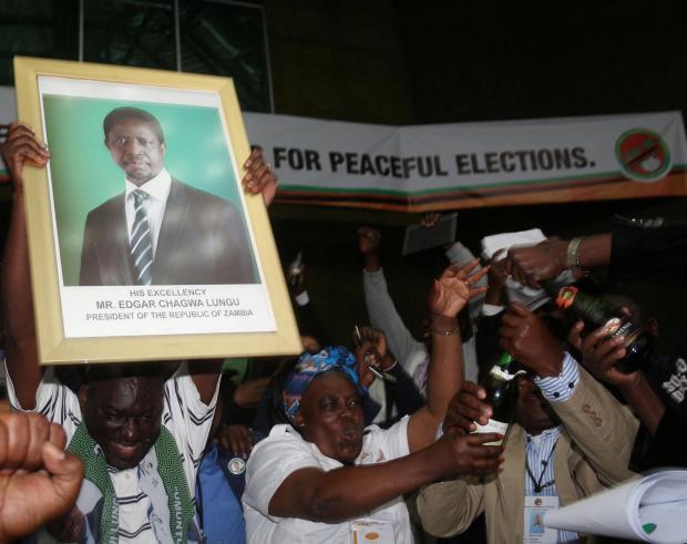 Supporters of incumbent Edgar Lumbu celebrate the electoral victory