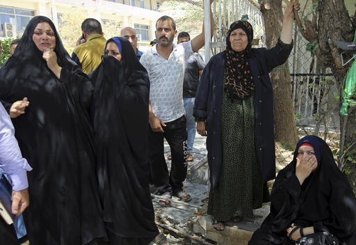 Families of newborn babies who died in a fire gather outside a maternity ward at Yarmouk hospital in western Baghdad Iraq Wednesday Aug. 10 2016. A fire ripped through the maternity ward at the Baghdad hospital overnight killing at least 11 newborn