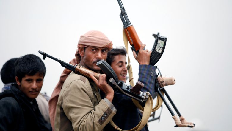 Tribesmen loyal to the Houthi movement ride on the back of a truck as they leave a tribal gathering they held to show support to a political council formed by the movement and the General People's Congress party to unilaterally rule Yemen by both gro