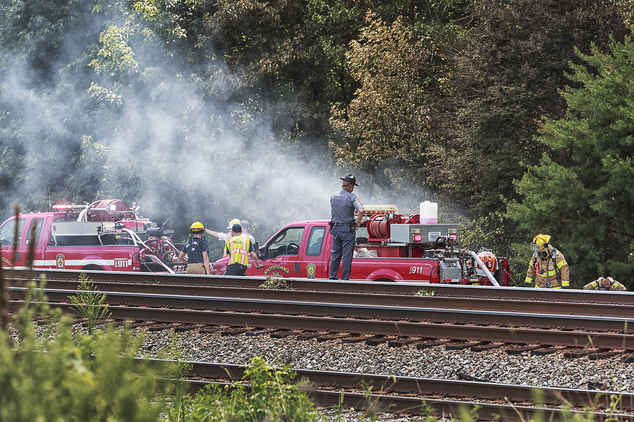 Emergency personnel investigate the scene of a plane crash near Shannon Airport Friday Aug. 12 2016 in Fredericksburg Va. Officials say at least two peop