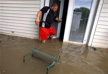 Wade Gary exits his home after viewing the damage in his studio apartment from floodwater Tuesday Aug. 16 2016 in Abbeville La