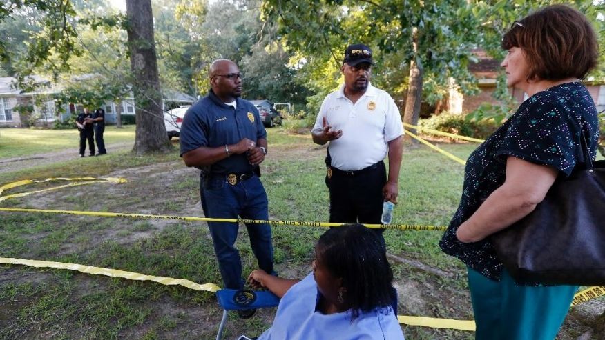 Durant Police Chief John Haynes left and assistant Police Chief James Lee reassure Lexington Medical Clinic employees Lisa Dew right and Viola Turner seated that the Mississippi Bureau of Investigation was giving the home of two slain Catholic nuns