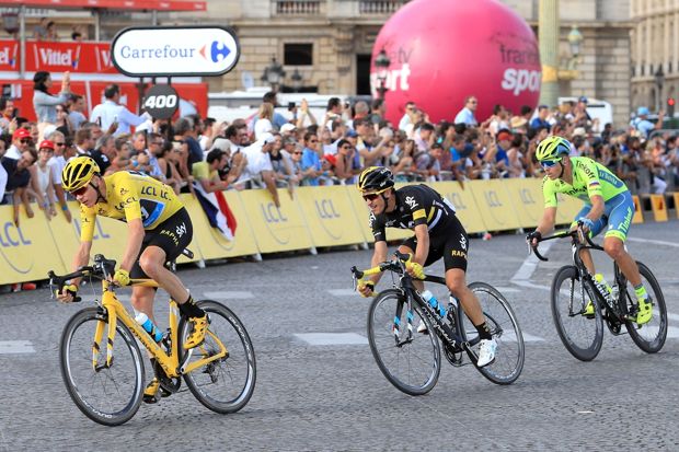 Froome left rides through the centre of Paris to complete his third Tour success